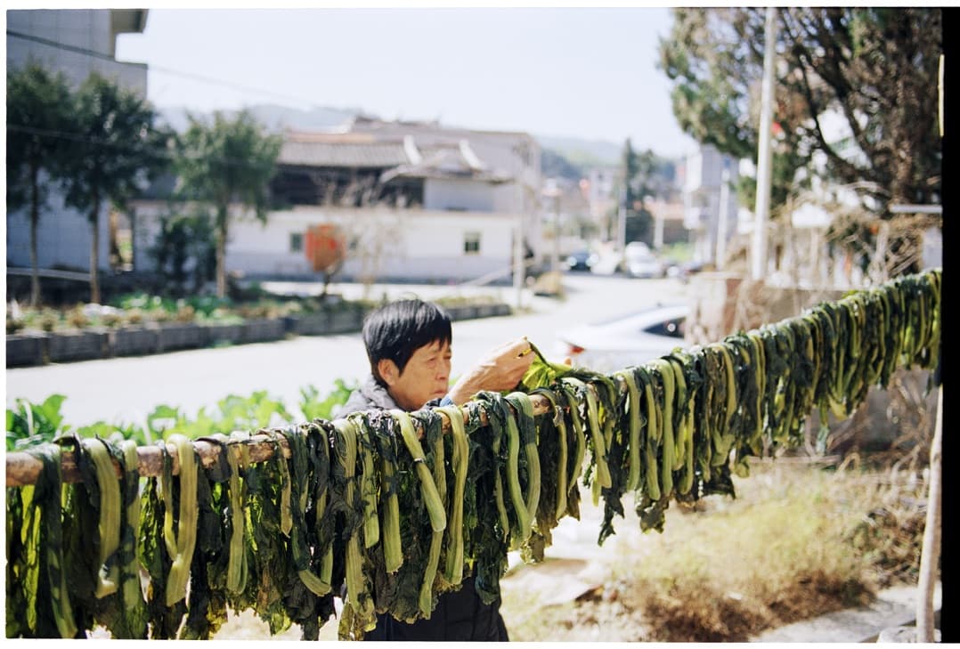 Our founder's grandmother in Fujian, drying mustard greens she grew and pickled by hand